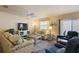 Bright living room featuring comfortable sofas, a coffee table, and a large TV at 3764 Ivey Ter, The Villages, FL 32163