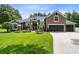 Two-story home with a three-car garage and manicured landscaping at 3811 Lorne Ct, Apopka, FL 32712