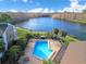 Aerial view of the community featuring a pool, lounge chairs, and lake access at 4668 Tower Pine Rd # Ge, Orlando, FL 32839