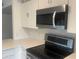 Sleek, stainless steel microwave and electric cooktop at 4668 Tower Pine Rd # Ge, Orlando, FL 32839