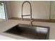 Modern kitchen sink with stainless steel basin and a pull-down faucet at 4668 Tower Pine Rd # Ge, Orlando, FL 32839