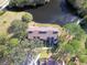 Aerial view of a condo complex situated by a lake, surrounded by lush greenery at 4668 Tower Pine Rd # Ge, Orlando, FL 32839