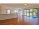 Open concept living and kitchen area with hardwood floors and patio access at 4668 Tower Pine Rd # Ge, Orlando, FL 32839