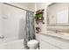 Clean bathroom with granite countertop, white cabinets, and patterned shower curtain at 4861 Panga Ave, Mount Dora, FL 32757