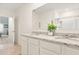 Double vanity bathroom with granite countertop and white cabinets at 4861 Panga Ave, Mount Dora, FL 32757