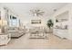 Living room with gray sofa, coffee table, and ceiling fan at 4861 Panga Ave, Mount Dora, FL 32757