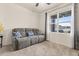 Relaxing living room featuring a gray reclining sofa and large window at 4861 Panga Ave, Mount Dora, FL 32757