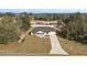House in a wooded neighborhood with a long driveway at 51 Aspen Rd, Ocala, FL 34480