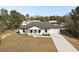 Aerial view of a single story home with a large driveway at 51 Aspen Rd, Ocala, FL 34480