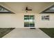 Covered patio with ceiling fan and sliding glass doors at 51 Aspen Rd, Ocala, FL 34480
