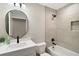 Modern bathroom with white vanity, black fixtures, and a beige tiled shower/tub combo at 51 Aspen Rd, Ocala, FL 34480
