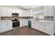 Modern kitchen featuring white cabinets and stainless steel appliances at 51 Aspen Rd, Ocala, FL 34480