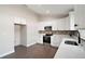 Modern kitchen with white cabinets and stainless steel appliances at 51 Aspen Rd, Ocala, FL 34480