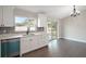 Modern kitchen with white cabinets, quartz countertops and teal dishwasher at 51 Aspen Rd, Ocala, FL 34480