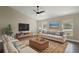 Spacious living room with a beige couch and large windows at 51 Aspen Rd, Ocala, FL 34480