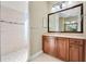 Bathroom with walk-in shower, wood vanity, and large mirror at 6027 Spinnaker Loop, Lady Lake, FL 32159