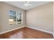 Spacious bedroom with hardwood floors and a ceiling fan at 6027 Spinnaker Loop, Lady Lake, FL 32159