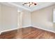 Spacious bedroom with hardwood floors and access to hallway at 6027 Spinnaker Loop, Lady Lake, FL 32159