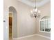 Dining room with tile floor, chandelier, and access to kitchen at 6027 Spinnaker Loop, Lady Lake, FL 32159