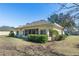 Single-story house with screened porch and manicured lawn at 6027 Spinnaker Loop, Lady Lake, FL 32159
