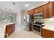 Kitchen with stainless steel appliances and wood cabinets at 6027 Spinnaker Loop, Lady Lake, FL 32159