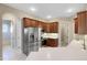 Modern kitchen with stainless steel appliances and wood cabinets at 6027 Spinnaker Loop, Lady Lake, FL 32159