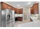 Modern kitchen with stainless steel appliances and wood cabinets at 6027 Spinnaker Loop, Lady Lake, FL 32159