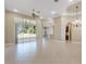Open concept living room with tile floors, access to patio and kitchen at 6027 Spinnaker Loop, Lady Lake, FL 32159