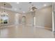 Spacious living room with tile floors, a ceiling fan, and chandelier at 6027 Spinnaker Loop, Lady Lake, FL 32159