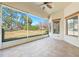 Spacious screened porch with tile flooring and ceiling fan at 6027 Spinnaker Loop, Lady Lake, FL 32159