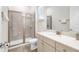 Clean bathroom with a walk-in shower, tiled floors, and modern vanity at 8059 Knee Deep Rd, Kissimmee, FL 34747