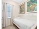 Small bedroom with twin bed, neutral decor, and large artwork at 8059 Knee Deep Rd, Kissimmee, FL 34747