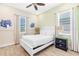 Bedroom with a white bed frame, tile floors, and coastal-themed artwork at 8059 Knee Deep Rd, Kissimmee, FL 34747