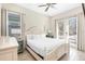 Bright bedroom with a king-size bed, nightstands, and access to a patio at 8059 Knee Deep Rd, Kissimmee, FL 34747