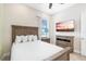 Bedroom with a comfortable bed, neutral decor, and a mounted TV at 8059 Knee Deep Rd, Kissimmee, FL 34747