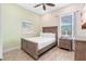 Bright bedroom with a wooden frame bed, tile floors, and plenty of natural light at 8059 Knee Deep Rd, Kissimmee, FL 34747