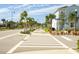 Wide paved walkway winds through a charming community with lush landscaping and palm trees at 8059 Knee Deep Rd, Kissimmee, FL 34747