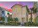 Charming two-story yellow home with a light teal door and balcony at 8059 Knee Deep Rd, Kissimmee, FL 34747