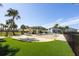 Community pool area with sand, grass, and lounge chairs at 8059 Knee Deep Rd, Kissimmee, FL 34747