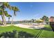 Community pool with sandy beach entry and lounge chairs at 8059 Knee Deep Rd, Kissimmee, FL 34747