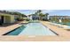 Community pool with lounge chairs and a pool house at 8059 Knee Deep Rd, Kissimmee, FL 34747