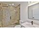 Modern bathroom with frameless glass shower, marble vanity, and updated fixtures at 8338 Se 178Th Deveaux Ln, The Villages, FL 32162