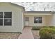 Inviting front entrance with a quaint walkway, well-maintained landscaping, and a charming exterior at 8338 Se 178Th Deveaux Ln, The Villages, FL 32162