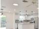 Modern kitchen featuring stainless steel appliances, granite countertops, and stylish pendant lighting at 8338 Se 178Th Deveaux Ln, The Villages, FL 32162
