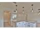 Bright kitchen with gray granite countertops and pendant lighting at 8338 Se 178Th Deveaux Ln, The Villages, FL 32162