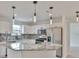 Modern kitchen featuring stainless steel appliances, granite countertops, and stylish pendant lighting at 8338 Se 178Th Deveaux Ln, The Villages, FL 32162