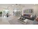 Bright, open-concept living room with modern furniture and decor, flowing into the kitchen and dining area at 8338 Se 178Th Deveaux Ln, The Villages, FL 32162