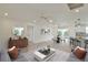 Spacious living area with dining and kitchen featuring modern decor and ample natural light at 8338 Se 178Th Deveaux Ln, The Villages, FL 32162