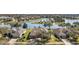 Aerial view of a residential community featuring lakefront homes, manicured lawns, and beautiful landscaping at 8920 Bridgeport Bay Cir, Mount Dora, FL 32757