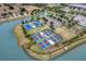Aerial view of community with tennis courts, pickleball courts, and scenic water views at 8920 Bridgeport Bay Cir, Mount Dora, FL 32757